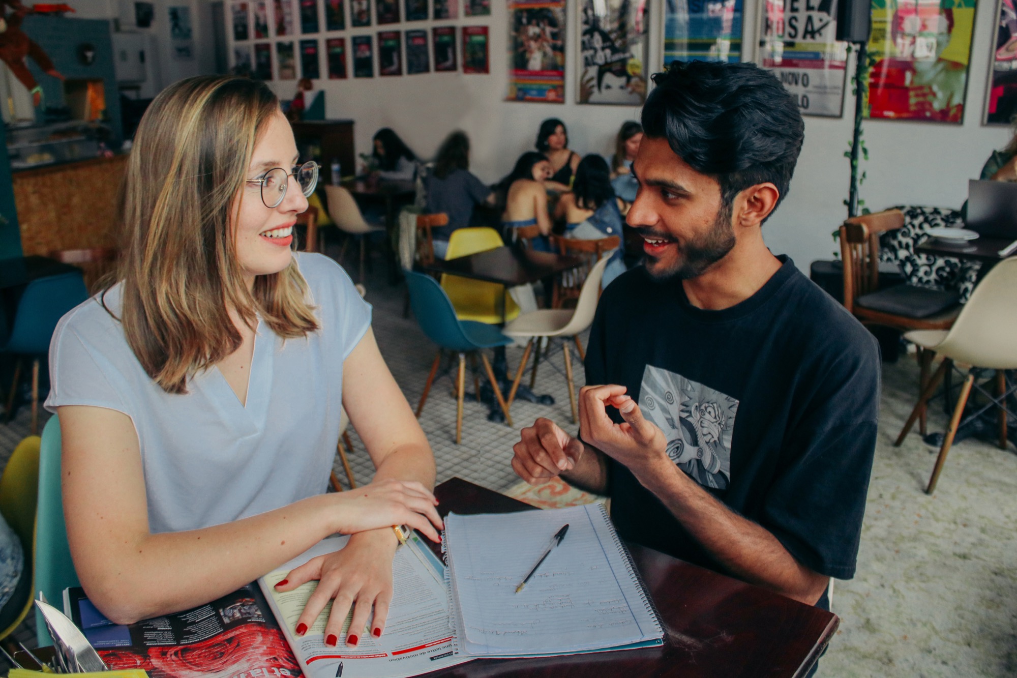 Virginie working through a French lesson 1-on-1 with a student at a café
