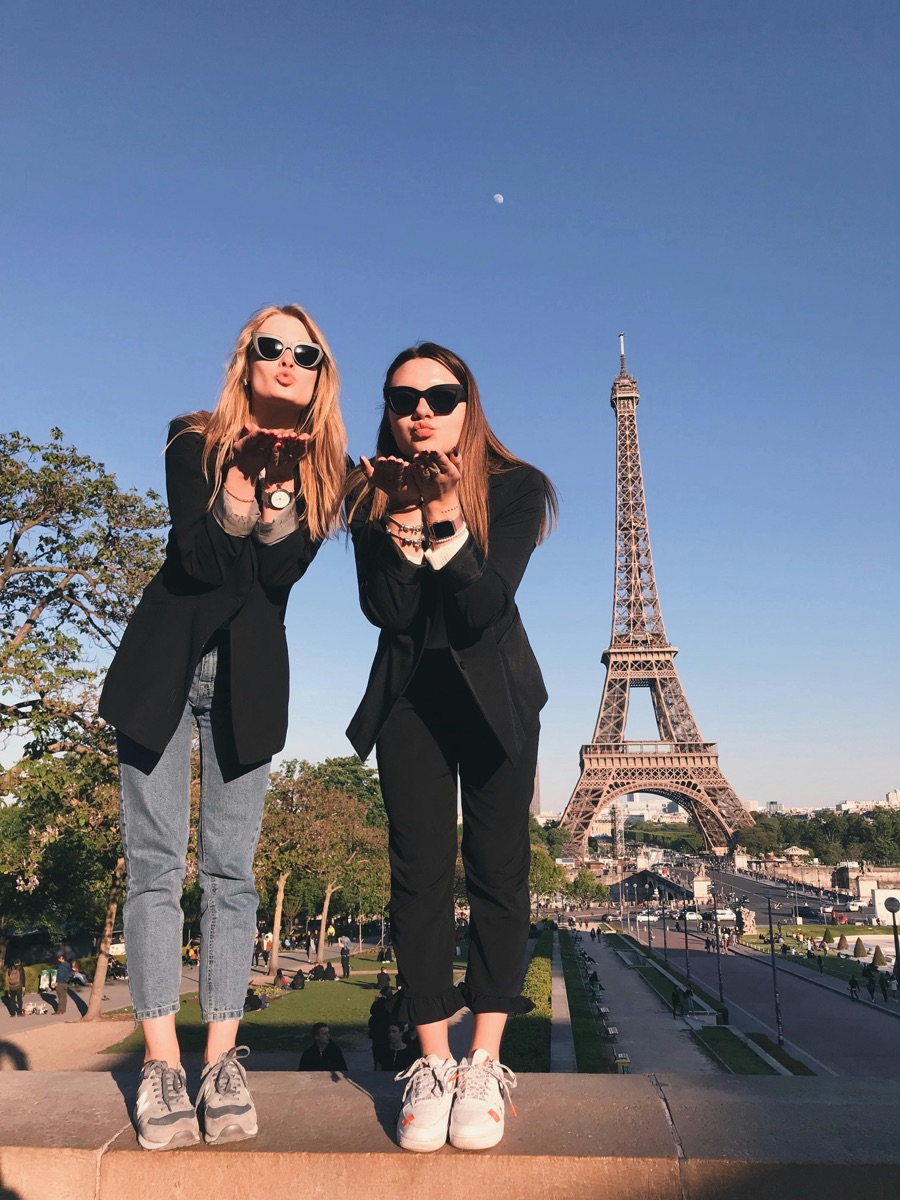 Two friends enjoying Paris by the Eiffel Tower