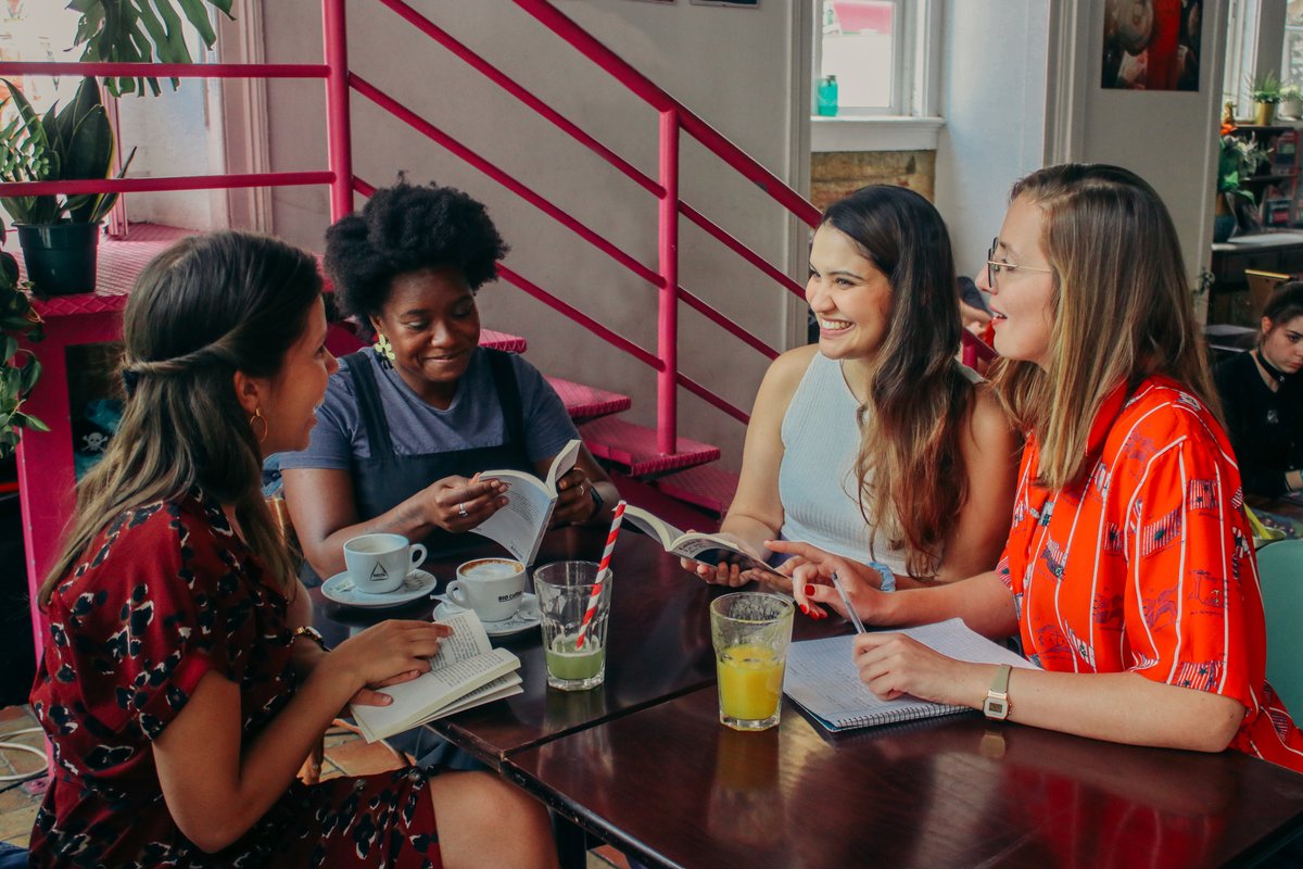 Four students learning French together at a café